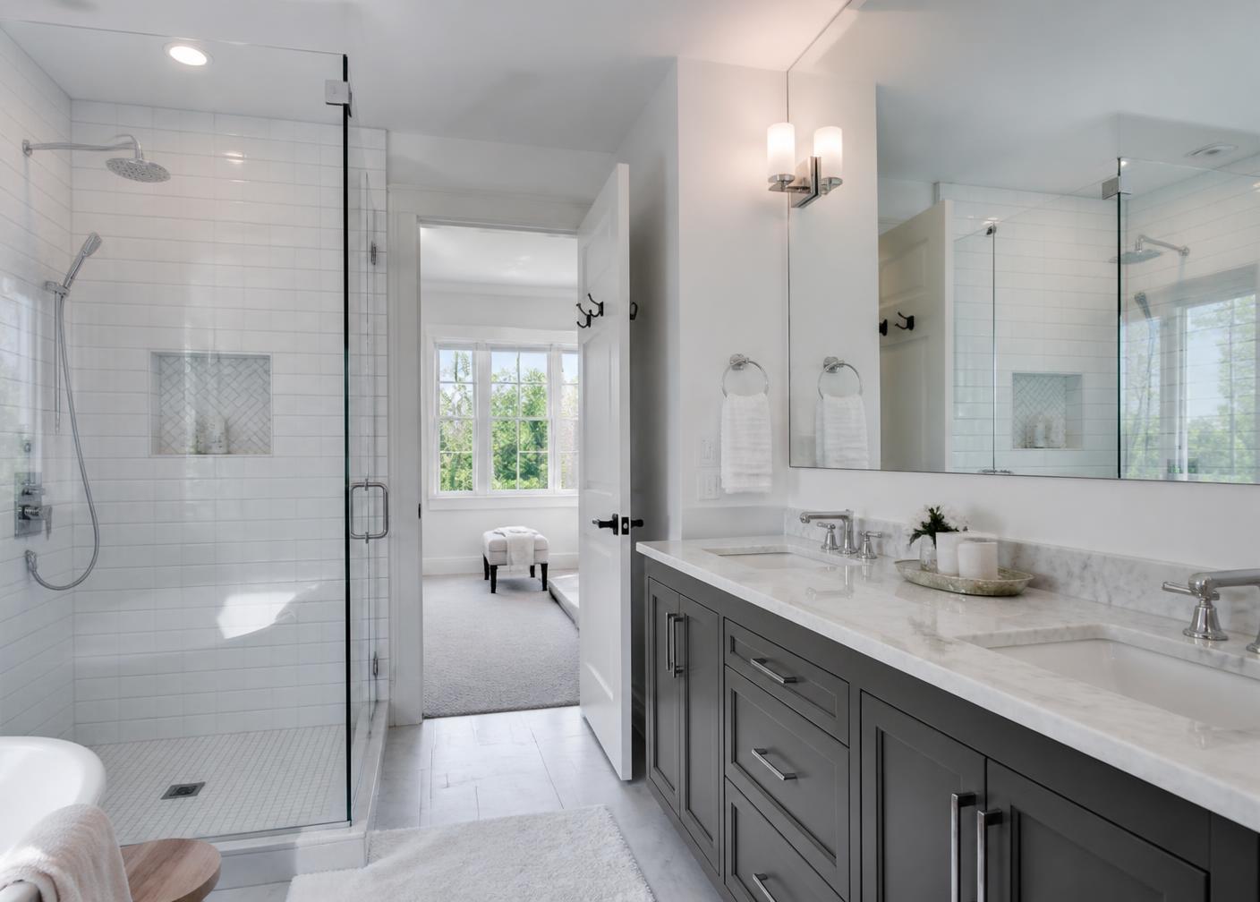 Clean modern bathroom with tiled shower and marble vanity